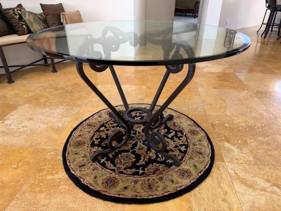 Round Glass Top Entry Table With Wrought Iron Scrollwork Pedestal Base (46'W X 31'H) On A Traditional Floral Medallion Circular Area Rug (43'W)