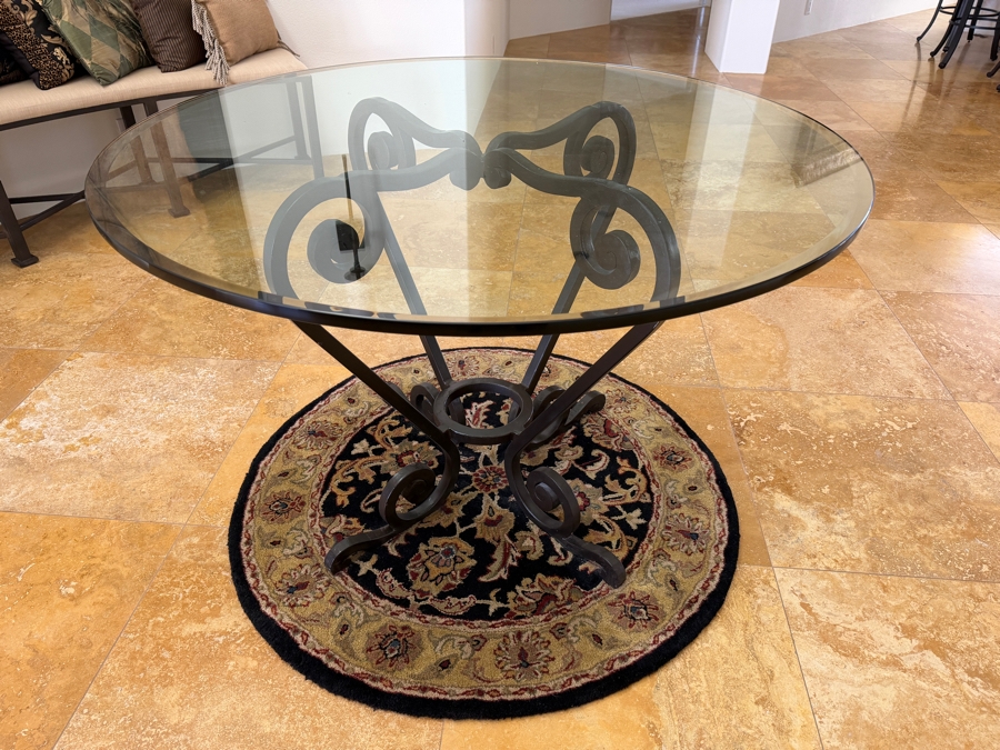 Round Glass Top Entry Table With Wrought Iron Scrollwork Pedestal Base (46'W X 31'H) On A Traditional Floral Medallion Circular Area Rug (43'W) [Photo 3]