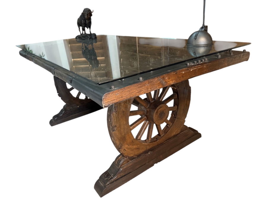 Custom Rustic Wagon Wheel Trestle Desk Featuring A Repurposed Antique Indian Door Top With Hand-Forged Iron Studs Strapping And Glass Top 72'W X 39'D X30'H
