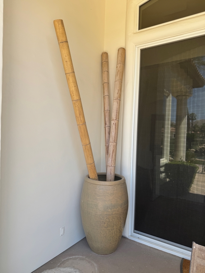 Large Tapered Tempayan Terracotta Urn Floor Vase In Weathered Ochre Patina Featuring Three Tall Oversized Natural Bamboo Decorative Poles Vase: 24'W X 43'H Bamboo: 120'H
