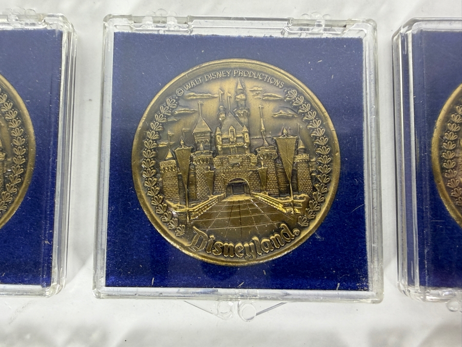 (6) Vintage Walt Disney Productions Bronze Disneyland Commemorative Medallion Featuring Sleeping Beauty Castle And Five Themed Lands In Plastic Display Cases [Photo 3]