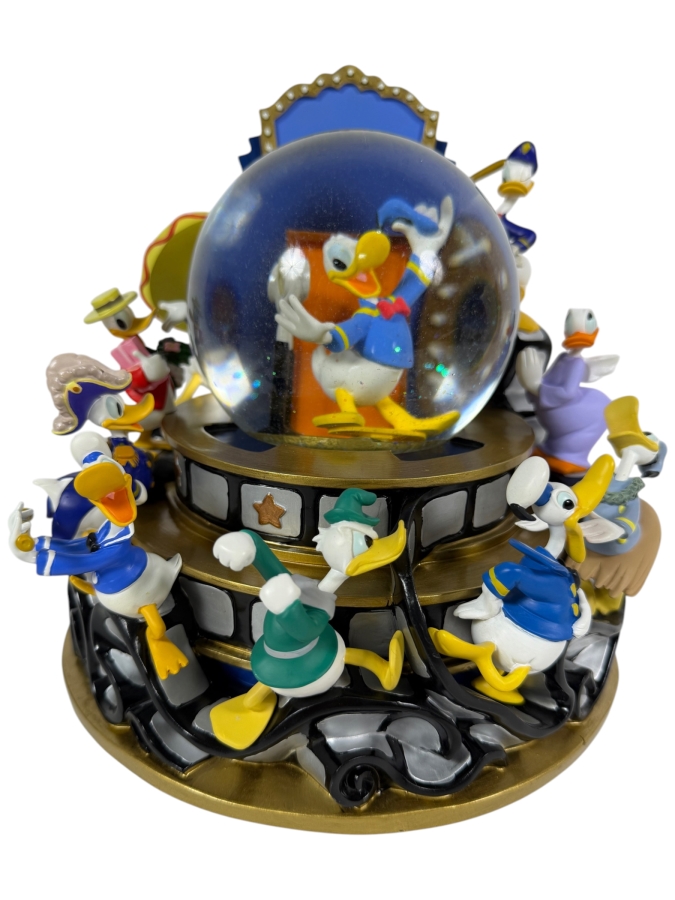 'Disney Donald Duck Through The Years' Musical Snow Globe Featuring Donald Duck in Various Outfits on a Rotating Filmstrip Base 9H
