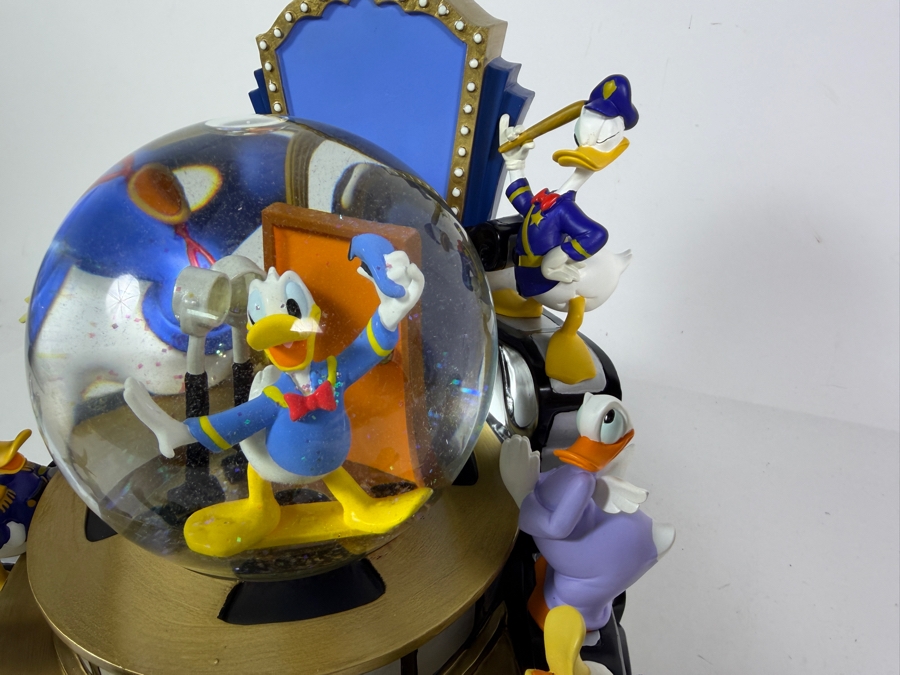 'Disney Donald Duck Through The Years' Musical Snow Globe Featuring Donald Duck in Various Outfits on a Rotating Filmstrip Base 9H [Photo 3]