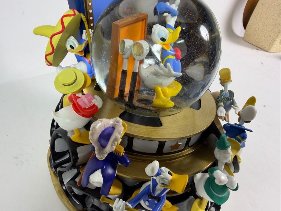 'Disney Donald Duck Through The Years' Musical Snow Globe Featuring Donald Duck in Various Outfits on a Rotating Filmstrip Base 9H [Photo 4]
