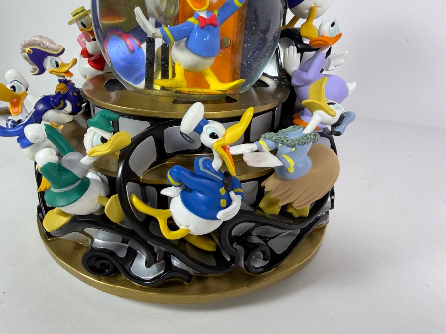 'Disney Donald Duck Through The Years' Musical Snow Globe Featuring Donald Duck in Various Outfits on a Rotating Filmstrip Base 9H [Photo 2]