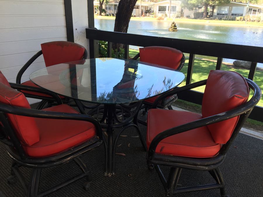 Outdoor Black Rattan Glass Top Table With Four Chairs On Casters [Photo 7]